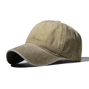 Side view of a washed khaki cotton baseball cap with a pre-curved brim and vintage texture