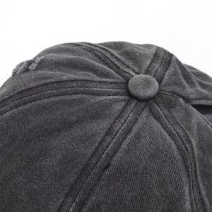 Macro detail of charcoal grey washed cotton baseball cap crown with six-panel stitching