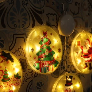 Detail of hanging LED Christmas window lights with suction cups in warm yellow glow