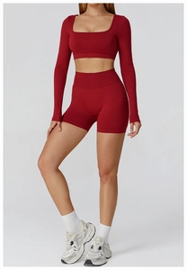 Detailed texture of seamless ribbed knit fabric on burgundy yoga crop top and shorts
