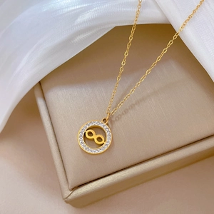 Golden titanium steel infinity necklace with sparkling rhinestones on an elegant jewelry box