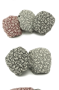 Close-up of vintage jacquard leaf pattern and texture on various beret flat caps