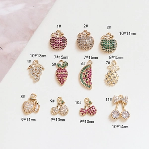 Macro shot of 11 assorted fruit zircon charms including apple and cherry for DIY jewelry
