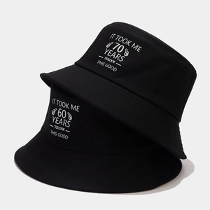 Classic black cotton bucket hats with 60 and 70 years birthday text printed on front