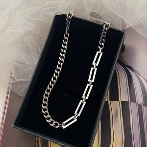 Silver titanium cuban chain necklace with mixed link design on a black jewelry box