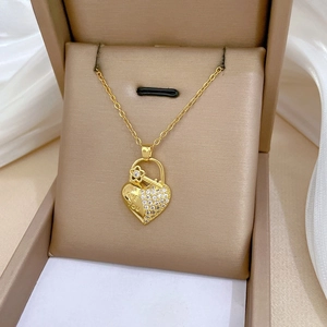 Detailed close-up of a heart pendant necklace with Love You engraving and white crystal inlay