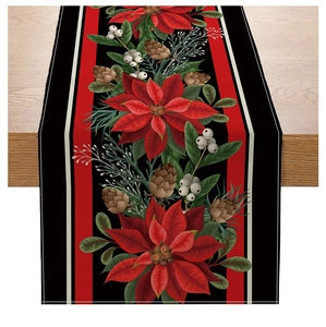 Detail of Christmas table runner with poinsettia and pine cones on striped fabric