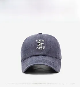 Close-up of vintage washed navy denim baseball cap with white NY embroidery