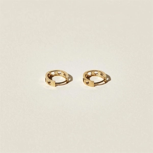 Minimalist gold heart cutout huggie earrings with polished finish and elegant design