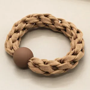 Thick braided hair tie in milk tea khaki with a matte coffee brown decorative bead