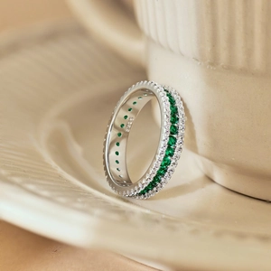 Macro detail of S925 silver ring featuring green and white zircon clover design stones