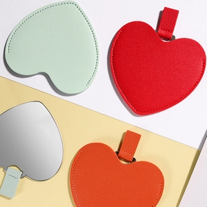 Portable heart-shaped stainless steel mirrors in colorful PU leather protective sleeves