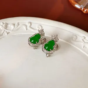 Elegant silver gourd earrings with green jadeite stone and zircon accents in a white tray