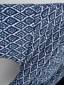 Macro shot of blue Y2K geometric diamond print and quilted stitching texture
