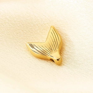 18k gold plated stainless steel mermaid tail pendant on soft beige silk background