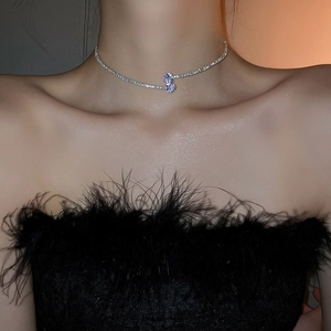 Close-up of double-layer silver bow necklace with zircons on model neck and collarbone
