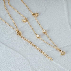 Close-up of gold butterfly pendant with micro-pave crystals and adjustable chain
