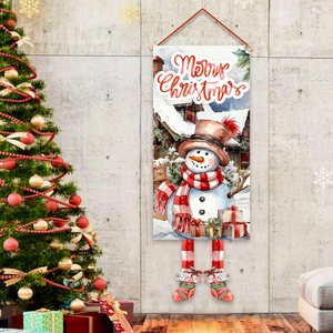 Merry Christmas banner with snowman design hung on wall next to a decorated tree