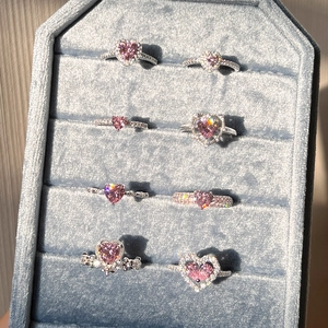Macro shot of S925 sterling silver rings with pink heart zircon and elegant crown details