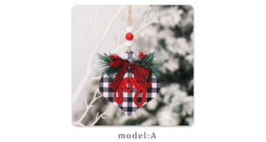 Detail of wooden heart Christmas ornament with black white buffalo plaid and red Joy text