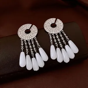 Silver drop fringe earrings with sparkling rhinestones and white teardrop beads on leather