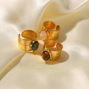 Three 18K gold plated stainless steel open rings with colorful gemstones on silk