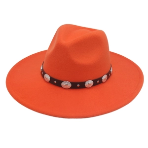 Detail of orange felt jazz hat featuring black leather band and silver metal studs