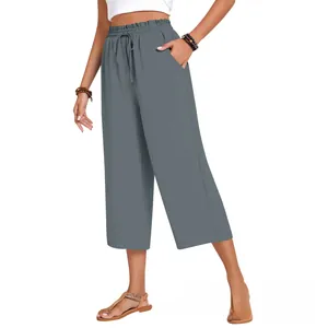 Detail of high waisted linen pants featuring an elastic drawstring waistband and side pockets