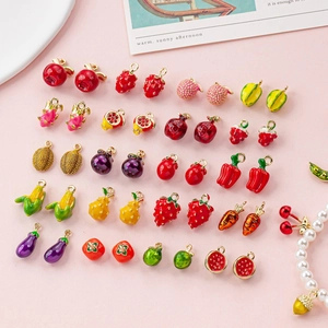 DIY colorful alloy fruit and vegetable charms for jewelry making on pink background