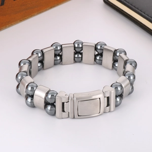 Detail of grey hematite beads and brushed stainless steel links with a secure folding clasp