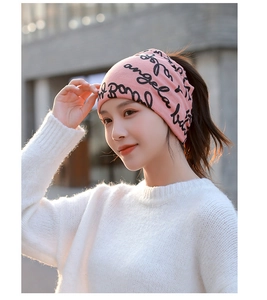 Close-up of pink knitted neck warmer with black handwritten artistic lettering for winter