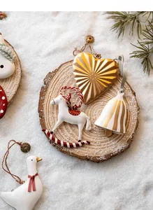Exquisite Christmas metal pendants set with golden hearts and bells on wood and snow