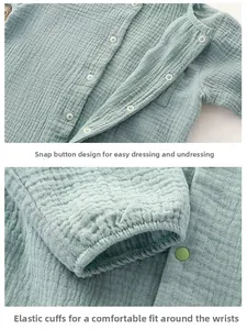 Detail of snap button closure and elastic cuffs on light green gauze baby romper