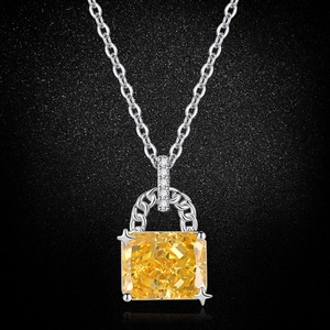 Macro detail of high carbon yellow gemstone pendant with icy flower cutting on silver chain