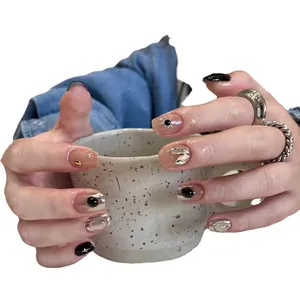 Handmade press-on nails with black graffiti and silver metallic sun heart design