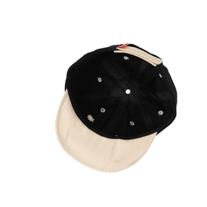 Vue intérieure de la casquette bébé bicolore avec broderie marguerite et coutures