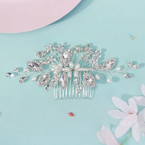 Elegant silver bridal hair comb featuring delicate rhinestones and pearls on blue background