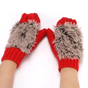 Close-up view of red winter mittens featuring fluffy plush animal back design and warm knit cuff.