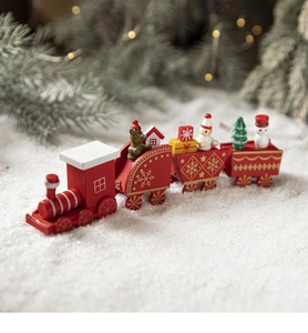 Macro view of a 4-section red wooden Christmas train with mini snowmen and pine trees