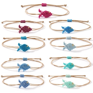 Handmade woven fish bracelets in various colors with adjustable strings and gold beads