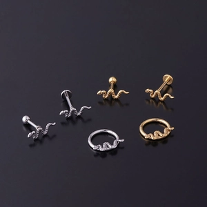 Detailed view of 16G stainless steel snake-shaped stud and hoop body jewelry set