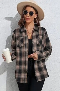 Detail of classic long-sleeved plaid flannel shirt with front pockets and button closure