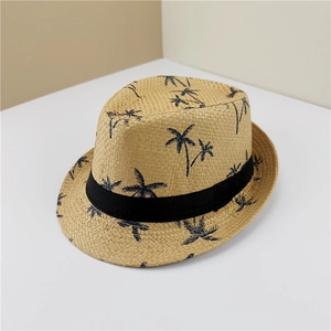 Close-up of woven straw jazz hat featuring palm tree prints and a black ribbon band