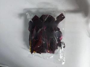 Detailed view of burgundy velvet Christmas bows in a bag shown with a measuring tape