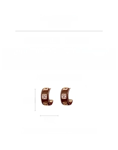 Detail view of C-shaped earrings with brown enamel, square zircon, and size dimensions