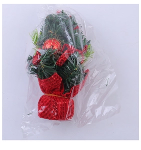 Mini Christmas tree ornament in plastic packaging with red ribbons and shiny base