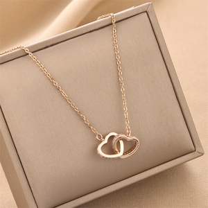 Elegant rose gold double heart interlocking necklace with crystals on jewelry box
