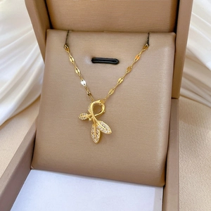 Close-up of gold leaf pendant with pavé set crystals on a sparkling star link chain