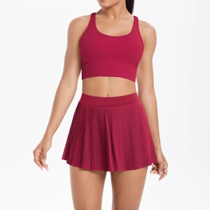 Close-up of wine red tennis set with pleated skirt and racerback sports bra for gym