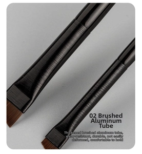 Close-up of angled makeup brushes with thickened brushed aluminum tubes and synthetic bristles